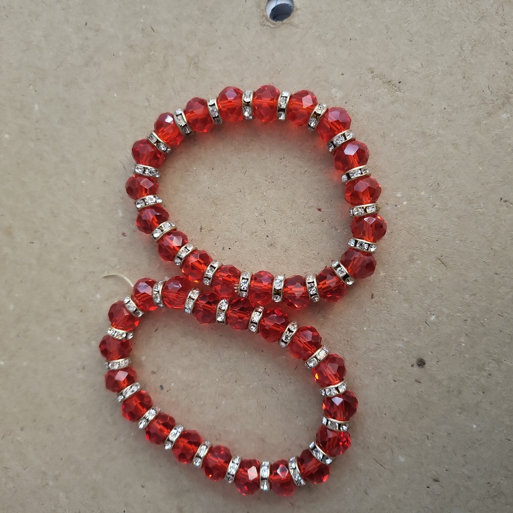 Red color glass beaded stretch bracelet with crystal spacer beads. All red round